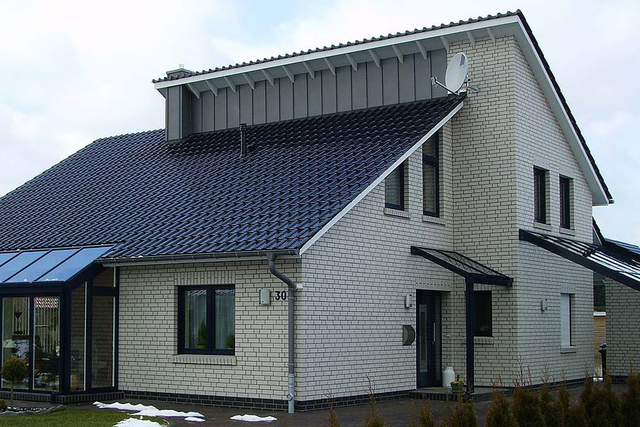 Haus mit Klinkern in creme-weiß und Dach in anthrazit